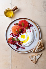 Labneh middle eastern lebanese cream cheese dip. Labneh with grapefruit,  roasted beetroot, pomegranate, fennel, sumac.