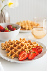 Belgian waffles with strawberry on white plate. Breakfast food concept