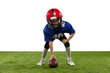 Athletic kid, beginner american football player in sports uniform and helmet training isolated on...