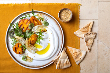 Labneh middle eastern lebanese cream cheese dip. Fennel apricot grilled barbecue salad with Labneh. Top view, overhead