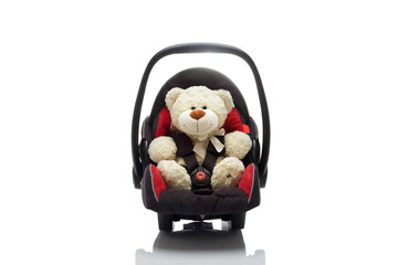 Toy bear in car seat for kids isolated on white background.