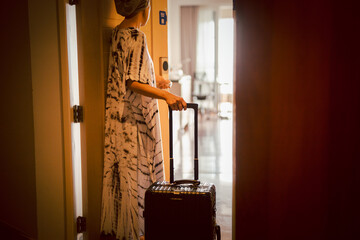 Tourist woman open the door of hotel room, Vacation conceptual.