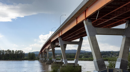 Mission Bridge over Fraser River during Sunny and Cloudy Spring Season Day. Fraser Valley, British Columbia, Canada.