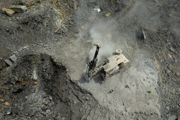 aerial view of excavator scooping rocks
