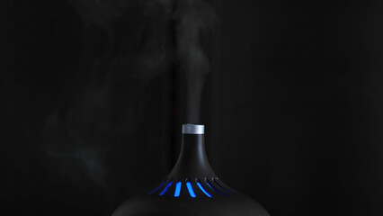 Close-up of humidifier. Action. Black designer humidifier with steam jet on dark background....