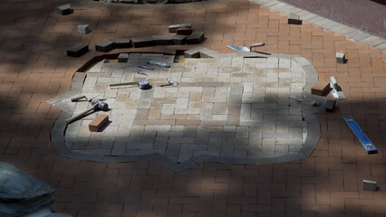 Construction site of custom designed two tone hardscaping brick paver project.
