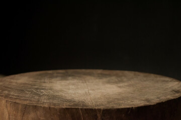 empty wooden round cutting board on black background use to place object