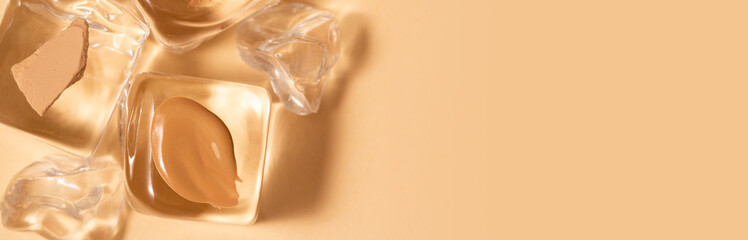 Samples of liquid foundation, concealer, compact powder on artificial ice cubes. Banner for professional makeup artist. Beige background. Summer face makeup, idea of cooling and refreshing cosmetics.