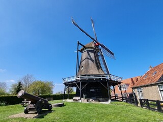 Historic mill "De Kaai" in (Dutch) Sloten (Frisian) Sleat, Friesland, Netherlands with medieval cannon