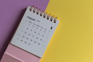 Desktop calendar for August 2022 on a yellow lilac background.