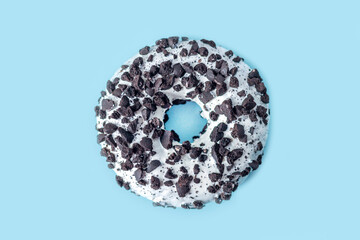 White chocolate glazed donut with cookies crumbs top view