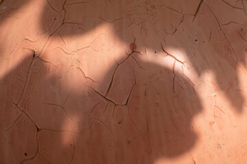 The cracked paint on an old metallic surface.