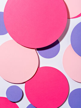 Background of colourful paper circles in Memphis geometric style.
