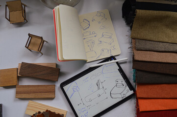 Furniture design process, digital drawing and analog drawing. Material design, natural wood, model, plant. wooden table, armchair design. Concept, person designing an armchair on digital tablet © rodrigo