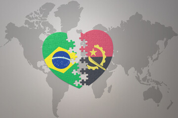 puzzle heart with the national flag of brazil and angola on a world map background.Concept.