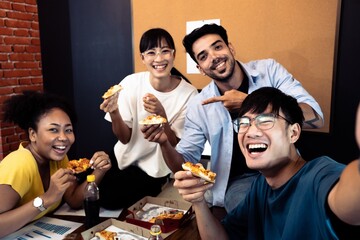 Diversity Group young friends eating pizza selfie by smart phone.People group multi ethnic African...