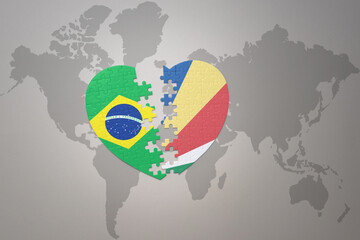 puzzle heart with the national flag of brazil and seychelles on a world map background.Concept.