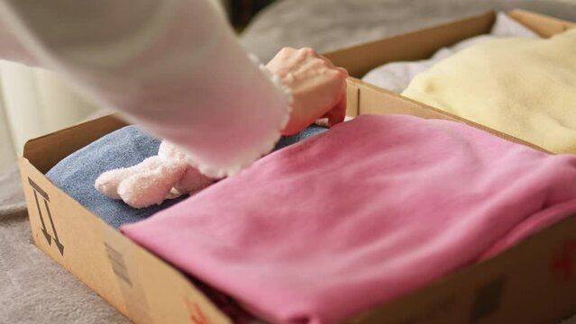Stack clothing for sorting and donation in cardboard boxes. Clothes for charity. Folding clothing storage and environmentally friendly consumption.