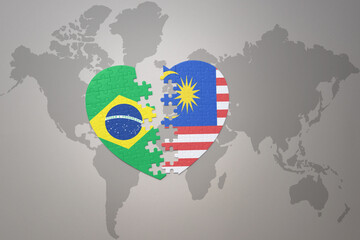 puzzle heart with the national flag of brazil and malaysia on a world map background.Concept.
