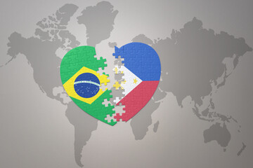 puzzle heart with the national flag of brazil and philippines on a world map background.Concept.