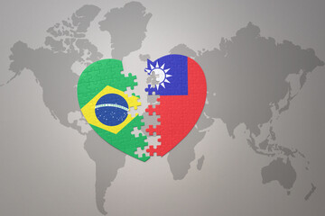 puzzle heart with the national flag of brazil and taiwan on a world map background.Concept.