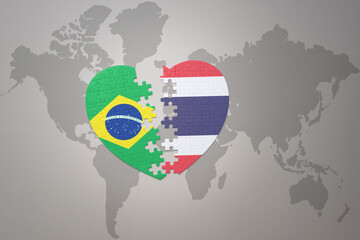 puzzle heart with the national flag of brazil and thailand on a world map background.Concept.