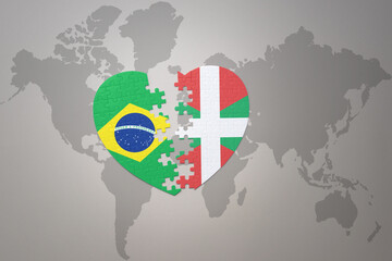 puzzle heart with the national flag of brazil and basque country on a world map background.Concept.