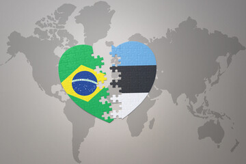 puzzle heart with the national flag of brazil and estonia on a world map background.Concept.