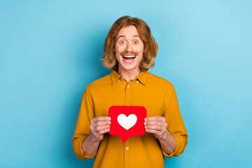 Portrait of attractive cheerful long-haired guy holding in hand like card yes having fun isolated...