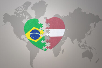 puzzle heart with the national flag of brazil and latvia on a world map background.Concept.