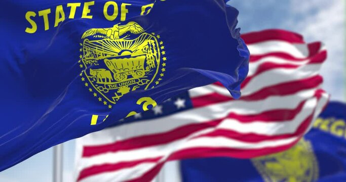 The Oregon state flag waving along with the national flag of the US