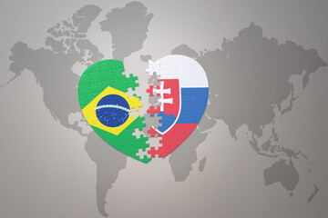 puzzle heart with the national flag of brazil and slovakia on a world map background.Concept.