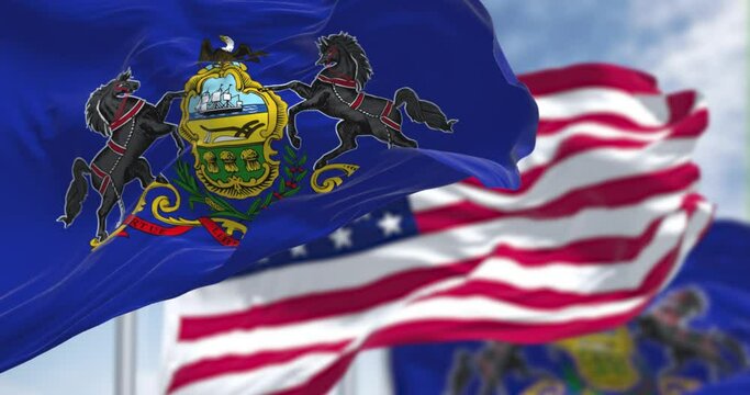 The Pennsylvania state flag waving along with the national flag of the US
