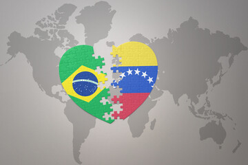 puzzle heart with the national flag of brazil and venezuela on a world map background.Concept.