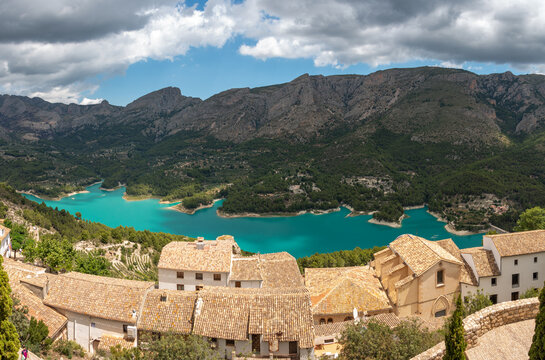 Panoramic view of the village of Guadalest with the Serrella mountain range in the background and the Guadalest reservoir in the province of Alicante, Spain