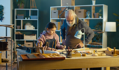 Caring Grandfather with his Teenage Granddaughter Spend Time Together, Work on Wood, Enjoying...