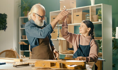 Caring Grandfather with his Teenage Granddaughter Spend Time Together, Work on Wood, Enjoying...