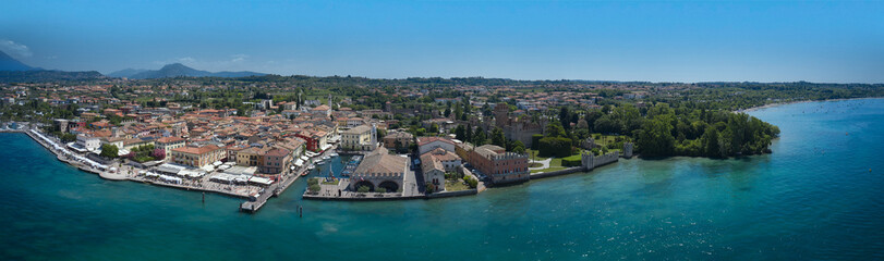 Fototapeta na wymiar Aerial panorama of Lazise town on Lake Garda Italy. Aerial view of Lazise city, Verona. The coastline is the historical part of the city of Lazise.