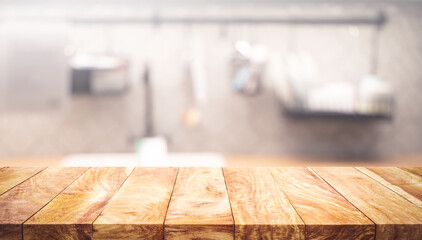 Selective focus.Wood table top on blur kitchen counter background.For montage product display or design key visual