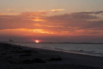 The Sun rises over the Cape May National Wildlife refuge as seen from the beach in cape may New Jersey