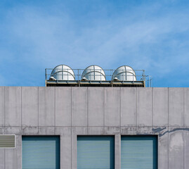 Fototapeta premium Pictures buildings' minimal style consists of concrete wall windows and ventilation pipes with a blue sky background.