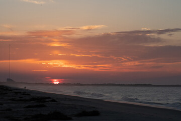 Fototapeta premium The Sun rises over the Cape May National Wildlife refuge as seen from the beach in cape may New Jersey