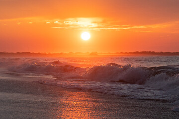 Ocean waves at sunrise off the shore of Cape May , New Jersey USA