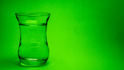 glass of water on a green background