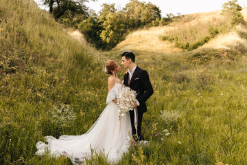 Stylish newlywed couple in love together in nature