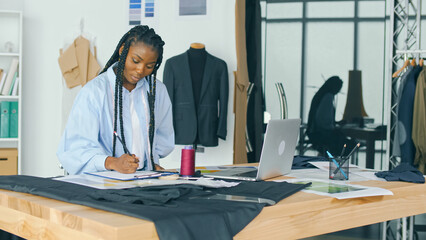 The Talented African-American Woman Fashion Designer Creates a New Fashion Collection While Enjoying a Moment of Inspiration While Working Alone in a Sunny Studio. New Ideas, Fashion Industry.