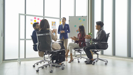 A group of Asian business team talk, communicate, discuss, and work in meeting room office, present ideas to colleagues. People lifestyle. Corporation