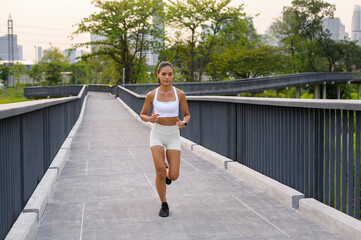 Young fitness woman in sportswear jogging in city park, Healthy and Lifestyles.