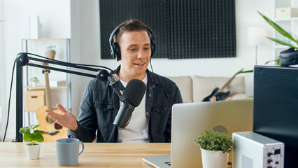 Content Creator, Social Media Influencer Hosts a Podcast While Working at the Computer and Interacting With the Audience in a Professional Studio. Concept of Online Meetings and Podcasts