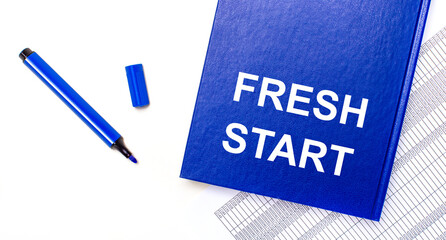 On a white background reports, a blue pen and a blue notebook with the text FRESH START. Business concept. Banner